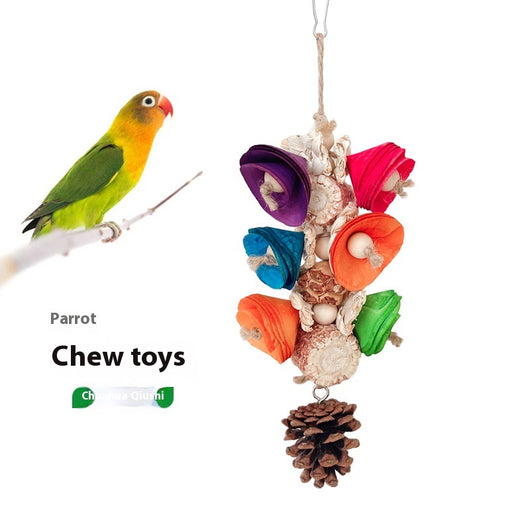 Blue parrot playing with a colorful natural material bird toy featuring corn cobs, wood, and pinecones, hanging in a white birdcage. - Image 16