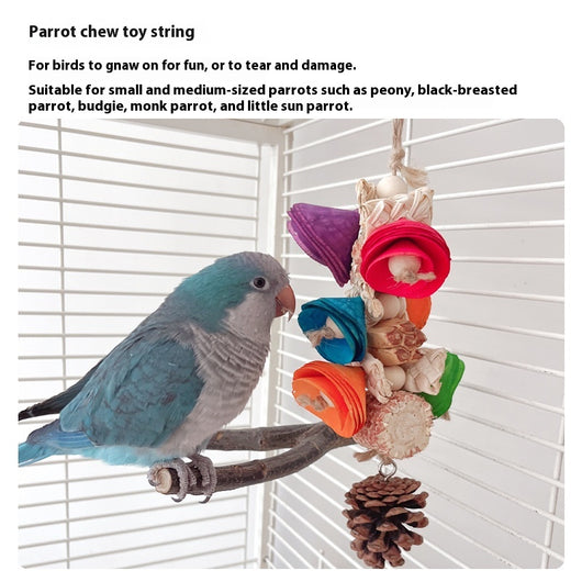 Blue parrot playing with a colorful natural material bird toy featuring corn cobs, wood, and pinecones, hanging in a white birdcage. - Image 20