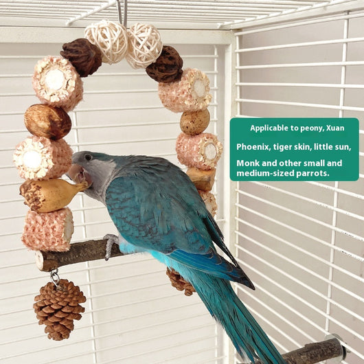 Natural wooden parrot swing with an arched top made of corn cobs, seed pods, and woven balls, featuring a log perch and two hanging pine cones. - Image 20