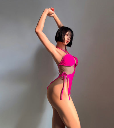 Black drawstring one-piece swimsuit with a ruched halter top and high-cut, tie-side bottom on a woman. - Image 20