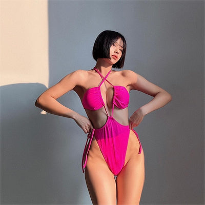Black drawstring one-piece swimsuit with a ruched halter top and high-cut, tie-side bottom on a woman. - Image 22