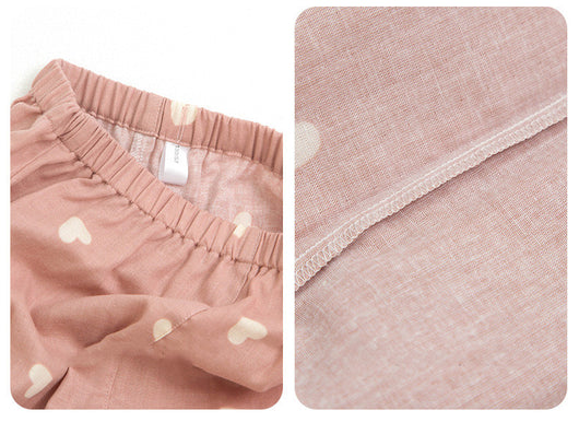 Pink long-sleeved pajama set for children with an all-over cherry print, Peter Pan collar, and matching pants. - Image 9
