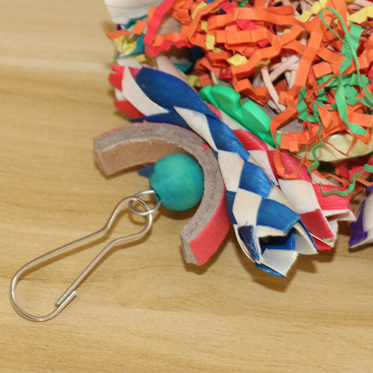 Colorful bird toy with paper tubes, shredded paper, and wooden beads, hanging inside a white wire bird cage. - Image 16