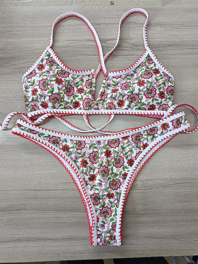 White two-piece swimsuit with red and green floral print, V-neck top, criss-cross straps, and high-cut bottoms. - Image 12
