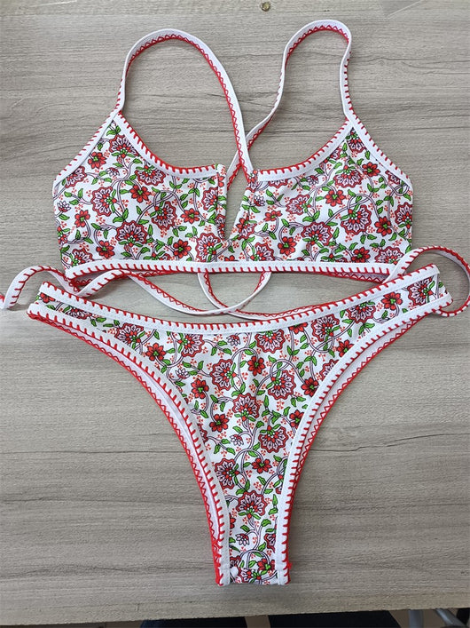 White two-piece swimsuit with red and green floral print, V-neck top, criss-cross straps, and high-cut bottoms. - Image 12