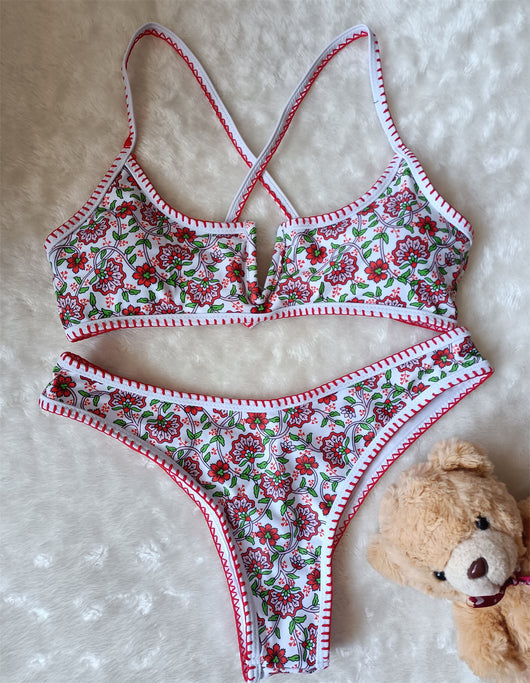 White two-piece swimsuit with red and green floral print, V-neck top, criss-cross straps, and high-cut bottoms. - Image 13