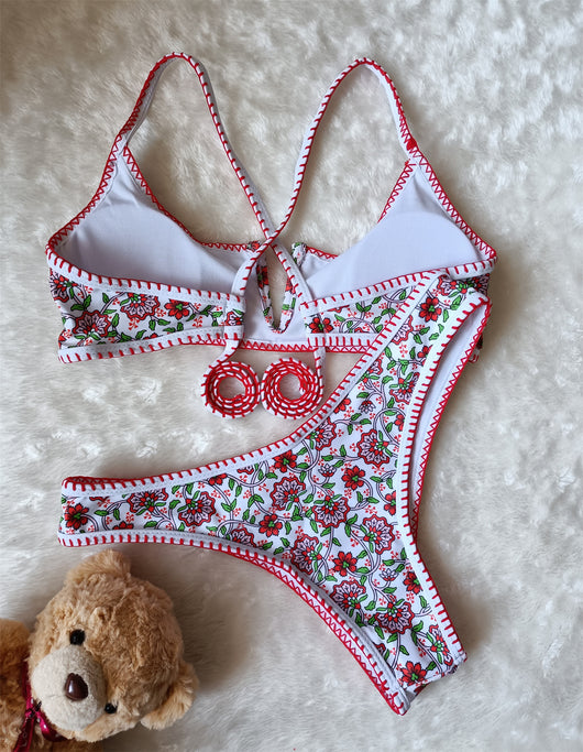 White two-piece swimsuit with red and green floral print, V-neck top, criss-cross straps, and high-cut bottoms. - Image 15