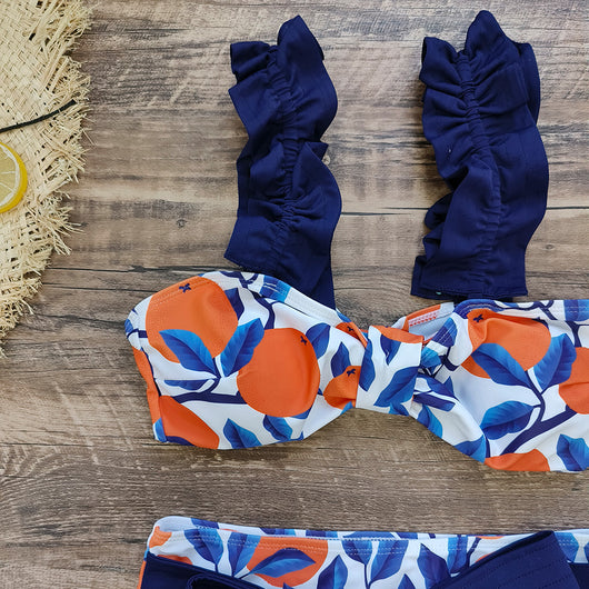 Women's high-waisted bikini swimsuit with orange and blue leaf print, ruffled navy blue straps, and a tie-front belt. - Image 10