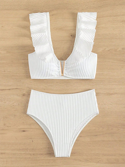 White ribbed bikini with ruffled shoulder straps and high-waisted bottoms on a model at a tropical beach. - Image 7