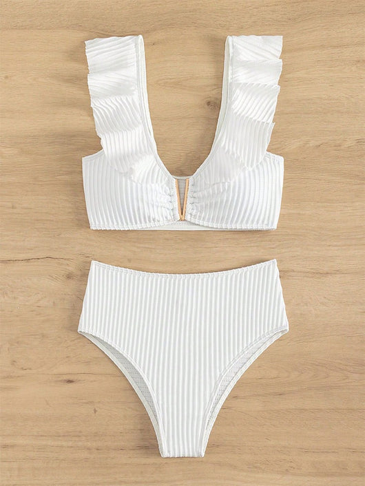 White ribbed bikini with ruffled shoulder straps and high-waisted bottoms on a model at a tropical beach. - Image 7