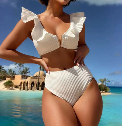 White ribbed bikini with ruffled shoulder straps and high-waisted bottoms on a model at a tropical beach. - Image 11