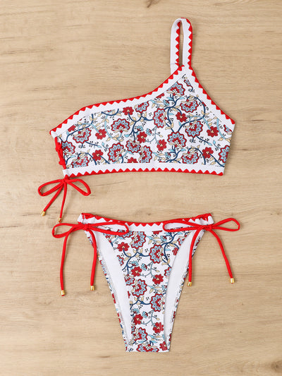 Women's one-shoulder bikini with red and blue floral print on white, featuring red trim and tie-side bottoms. - Image 31