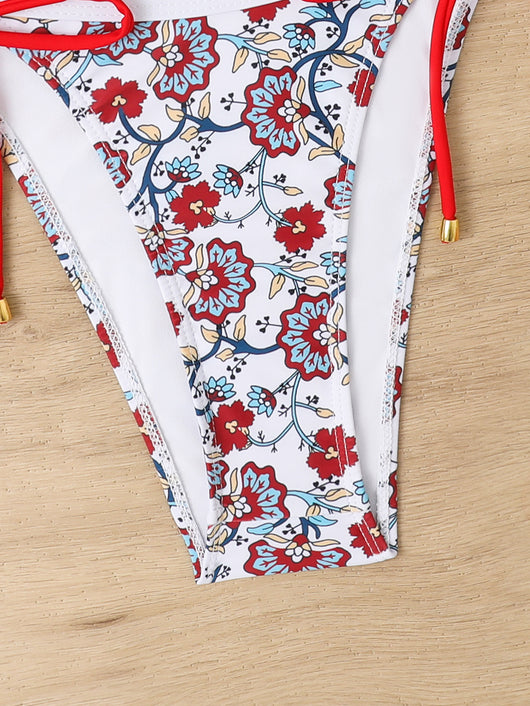 Women's one-shoulder bikini with red and blue floral print on white, featuring red trim and tie-side bottoms. - Image 32