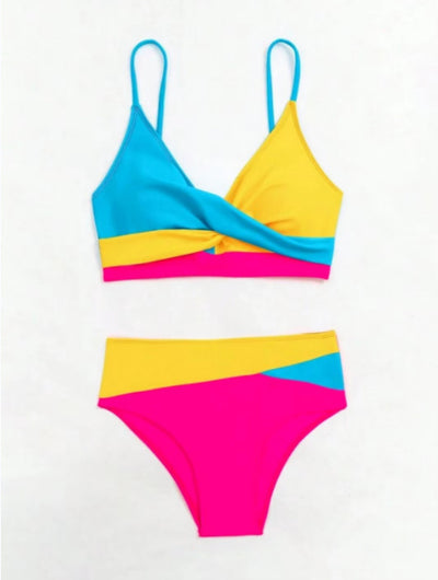 Woman wearing a blue color block split swimsuit with a wrapped front bikini top and high-waisted briefs. - Image 17