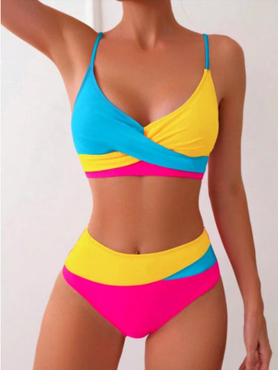 Woman wearing a blue color block split swimsuit with a wrapped front bikini top and high-waisted briefs. - Image 20