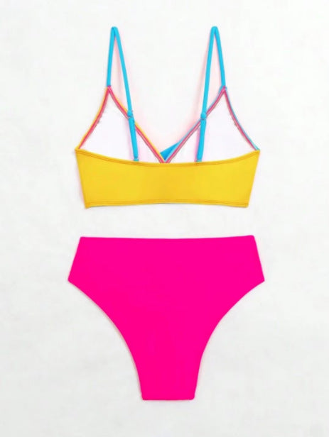 Woman wearing a blue color block split swimsuit with a wrapped front bikini top and high-waisted briefs. - Image 22