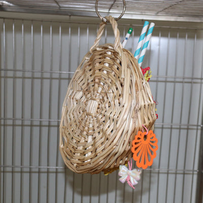 Woven basket bird toy filled with colorful shredded paper, paper tubes, and hanging chewable elements. - Image 11