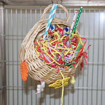 Woven basket bird toy filled with colorful shredded paper, paper tubes, and hanging chewable elements. - Image 13