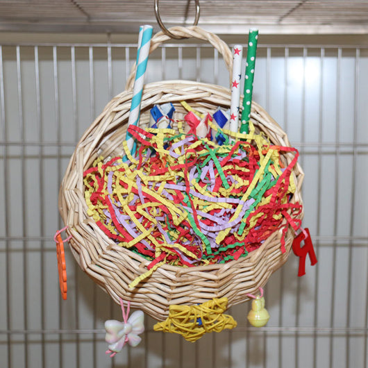Woven basket bird toy filled with colorful shredded paper, paper tubes, and hanging chewable elements. - Image 14