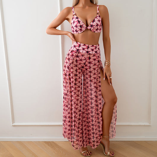 Women's pink, black, and white abstract striped bikini with a push-up top and strappy high-cut bottoms on a beach. - Image 43
