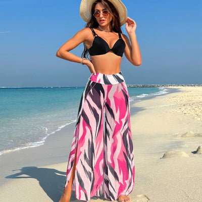 Women's pink, black, and white abstract striped bikini with a push-up top and strappy high-cut bottoms on a beach. - Image 63