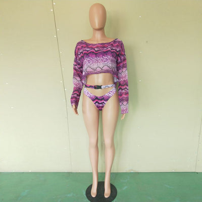 Woman in a purple and pink snakeskin print three-piece swimsuit with an off-shoulder crop top and high-waisted bottoms. - Image 46