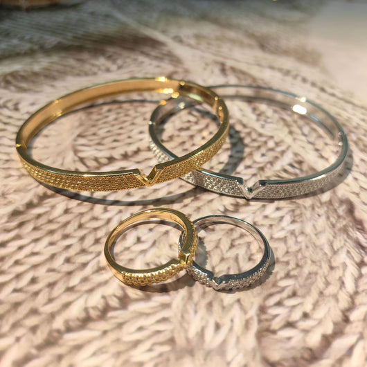 V-shaped 18K gold electroplated bracelet and ring set with pave clear stones on a white stand. - Image 14