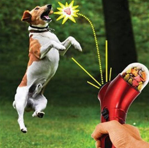 Red pet treat launcher with a clear reservoir filled with brown kibble, shown from side and top views with dimensions. - Image 9