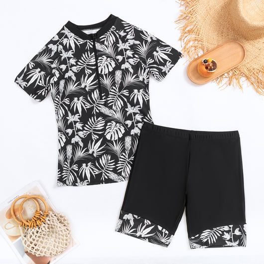 Women's black and white tropical leaf print short sleeve rash guard top with a quarter-zip, paired with solid black swim shorts featuring matching printed cuffs - Image 20
