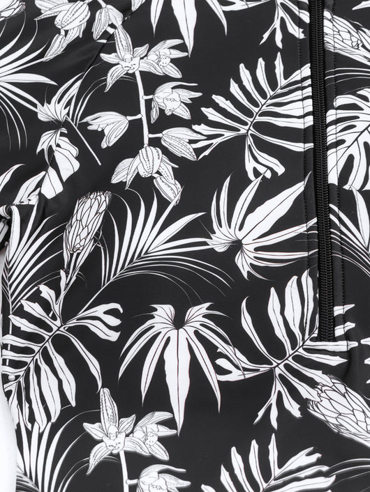 Women's black and white tropical leaf print short sleeve rash guard top with a quarter-zip, paired with solid black swim shorts featuring matching printed cuffs - Image 23