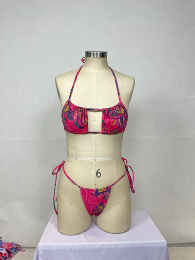 Women's pink paisley print bikini set with halter top featuring a cutout and tie-side thong bottoms. - Image 16