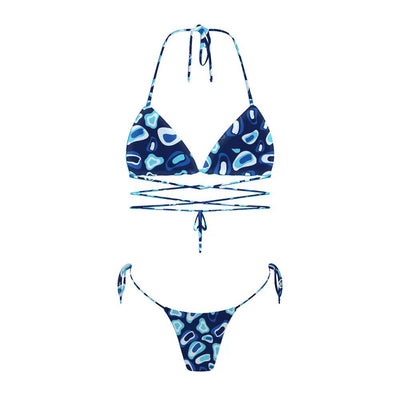 Woman in a light blue patterned triangle bikini with tie-side bottoms on a sandy beach with palm trees. - Image 36