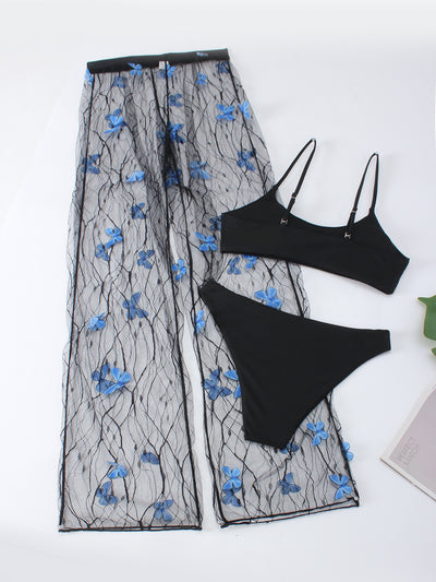 Women's black bikini three-piece set with a spaghetti strap top, matching bottoms, and sheer voile pants with blue butterfly appliques. - Image 14