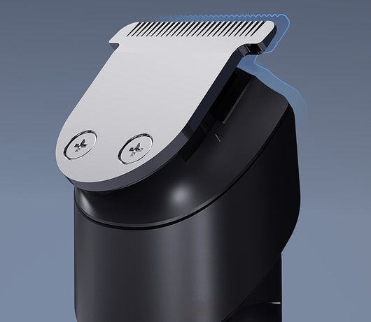 White electric hair clipper with a black top, silver blade, digital display, and power button on a dark base. - Image 16