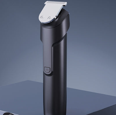 White electric hair clipper with a black top, silver blade, digital display, and power button on a dark base. - Image 17