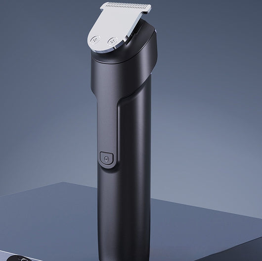 White electric hair clipper with a black top, silver blade, digital display, and power button on a dark base. - Image 17