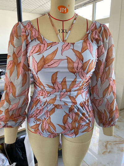 Women's light blue one-piece swimsuit with pink and orange leaf print, long sheer chiffon sleeves, and ruched details. - Image 17