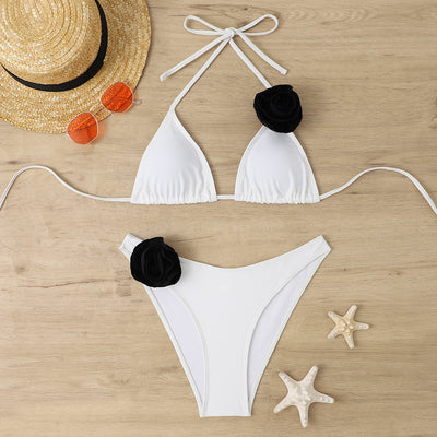 Woman wearing a white triangle bikini with a large 3D flower on the top and a smaller one on the bottom. - Image 27