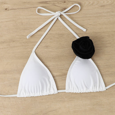 Woman wearing a white triangle bikini with a large 3D flower on the top and a smaller one on the bottom. - Image 28