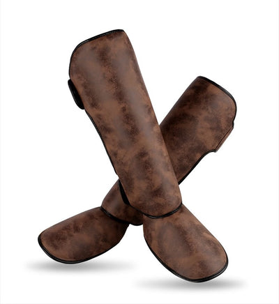 Pair of brown and black thickened shin guards for fighting and boxing, featuring a distressed leather-like texture. - Image 13