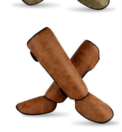 Pair of brown and black thickened shin guards for fighting and boxing, featuring a distressed leather-like texture. - Image 16