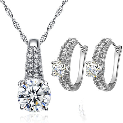 Gold-toned bridal necklace and hoop earrings set with large round cubic zirconia stones and pave accents. - Image 7