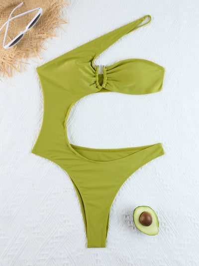 Woman wearing a black one-shoulder one-piece swimsuit with a side cutout and gold-tone ring detail. - Image 24