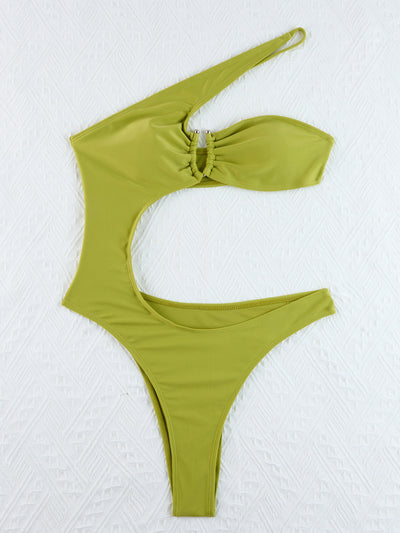 Woman wearing a black one-shoulder one-piece swimsuit with a side cutout and gold-tone ring detail. - Image 25