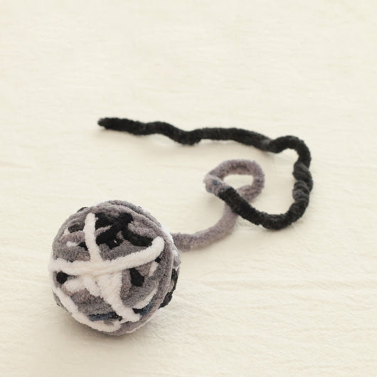 Colorful plush yarn ball cat toy in pink, blue, and white, with a long trailing strand, on a light background. - Image 45