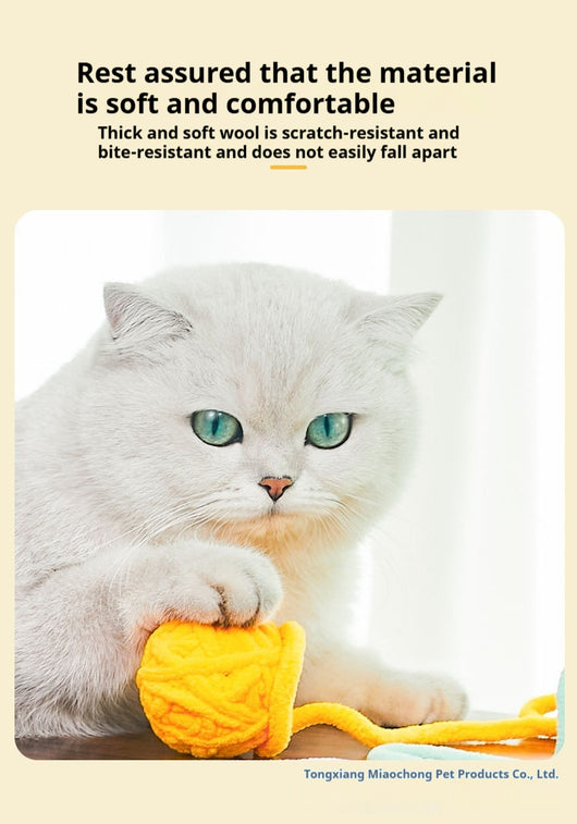 Colorful plush yarn ball cat toy in pink, blue, and white, with a long trailing strand, on a light background. - Image 53