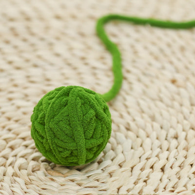 Colorful plush yarn ball cat toy in pink, blue, and white, with a long trailing strand, on a light background. - Image 59