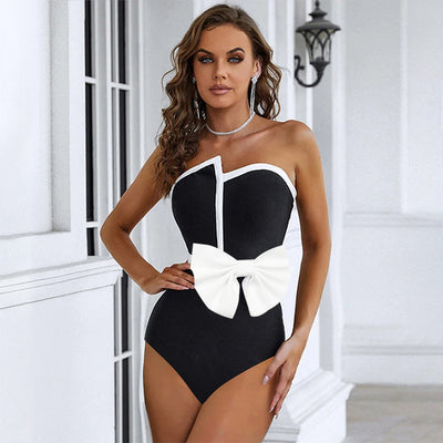 Black and white color-block one-piece swimsuit with an irregular tube top and a large white bow, paired with a matching pencil skirt. - Image 13