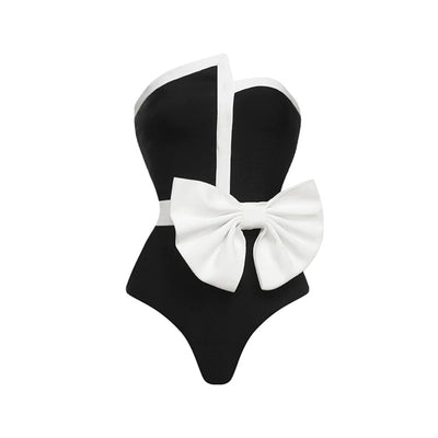 Black and white color-block one-piece swimsuit with an irregular tube top and a large white bow, paired with a matching pencil skirt. - Image 18