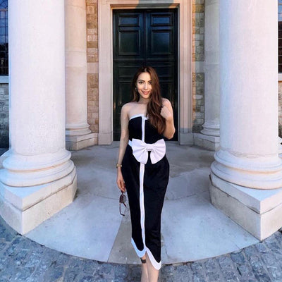 Black and white color-block one-piece swimsuit with an irregular tube top and a large white bow, paired with a matching pencil skirt. - Image 20